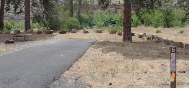 Parking pad, picnic table and fire ring at Big Pines Campsite #5