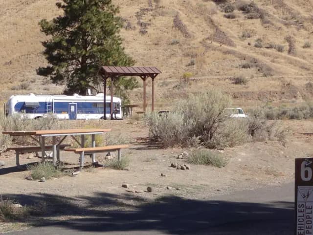 Parking pad, picnic table and fire ring at Big Pines Campsite #6