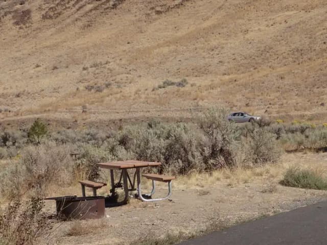 Parking pad, picnic table and fire ring at Big Pines Campsite #7