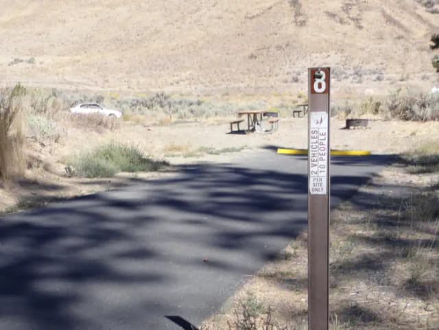 Parking pad, picnic table and fire ring at Big Pines Campsite #8