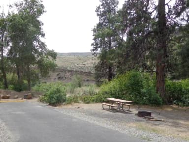 Parking pad, picnic table and fire ring at Big Pines Campsite #9