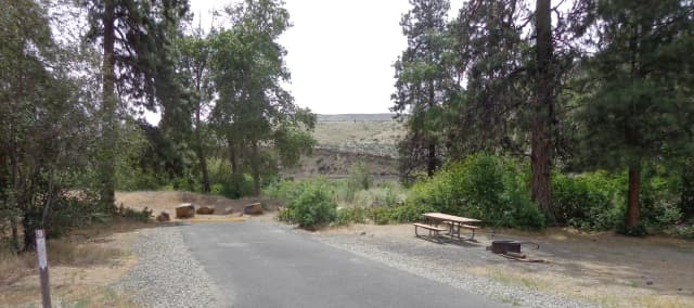Parking pad, picnic table and fire ring at Big Pines Campsite #9