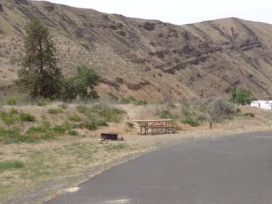 Parking pad, picnic table and fire ring at Big Pines Campsite #11