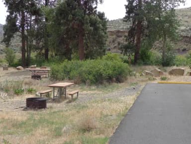 Parking pad picnic table and fire ring at Big Pines Campsite #14