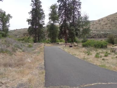 Parking pad, picnic table and fire ring at Big Pines Campsite #13