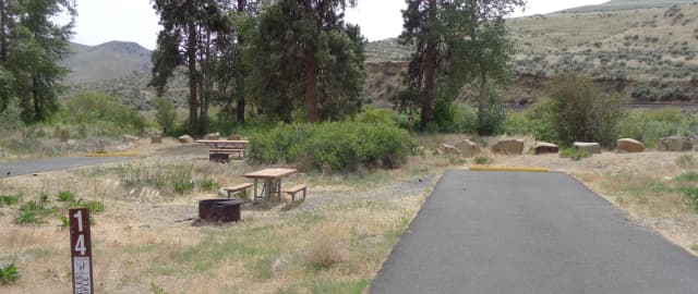 Parking pad picnic table and fire ring at Big Pines Campsite #14