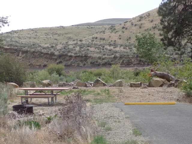 Parking pad, picnic table and fire ring at Big Pines Campsite #15