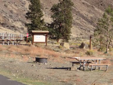 Parking pad, picnic table and fire ring at Big Pines Campsite #17