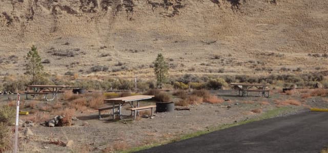 Parking pad, picnic table and fire ring at Big Pines Campsite #19