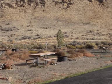 Parking pad, picnic table and fire ring at Big Pines Campsite #19