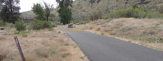 Parking pad, picnic table and fire ring at Big Pines Campsite #20