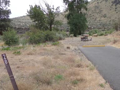 Parking pad, picnic table and fire ring at Big Pines Campsite #20