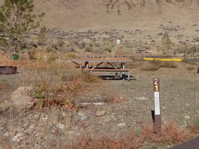 Parking pad, picnic table and fire ring at Big Pines Campsite #21