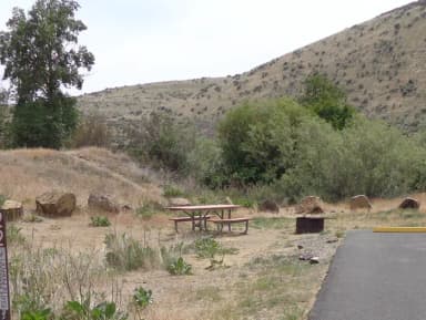 Parking pad, picnic table and fire ring at Big Pines Campsite #22