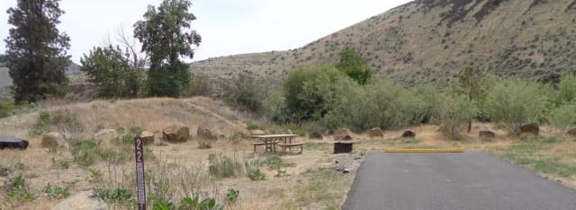 Parking pad, picnic table and fire ring at Big Pines Campsite #22