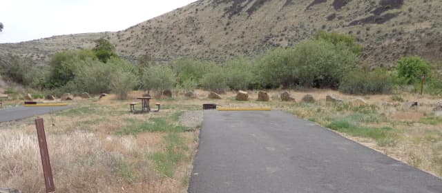Parking pad, picnic table and fire ring at Big Pines Campsite #23