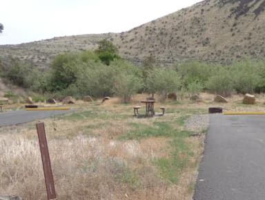 Parking pad, picnic table and fire ring at Big Pines Campsite #23