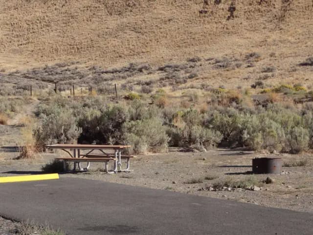 Parking pad, picnic table and fire ring at Big Pines Campsite #27