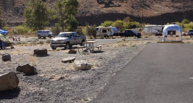 Parking pad, picnic table and fire ring at Big Pines Campsite #28