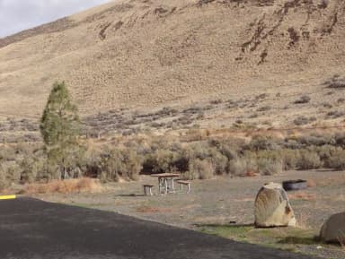 Parking pad, picnic table and fire ring at Big Pines Campsite #29