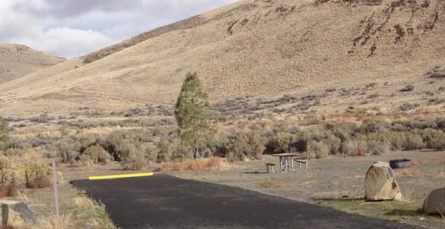 Parking pad, picnic table and fire ring at Big Pines Campsite #29
