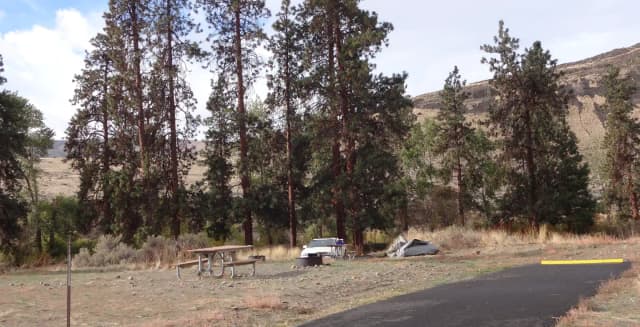 Parking pad, picnic table and fire ring at Big Pines Campsite #33