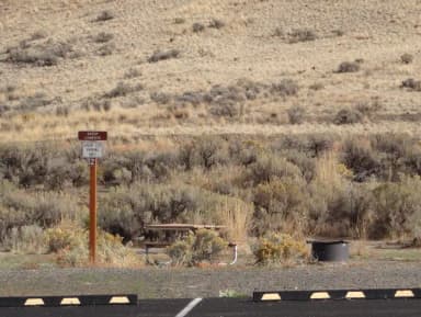 2 parking spots, 2 picnic tables and a fire ring at Big Pines Group Campsite #E