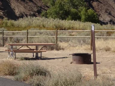 Picnic table, paved trail and fire ring at Big Pines Walk-in Campsite #B