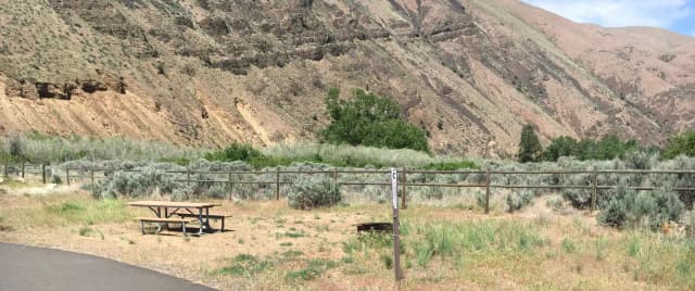 Picnic table, paved trail and fire ring at Big Pines Walk-in Campsite #C