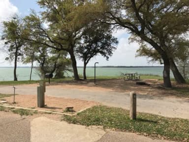 Pull through RV site with picnic table, grill, fire ring, and great view of Waco Lake