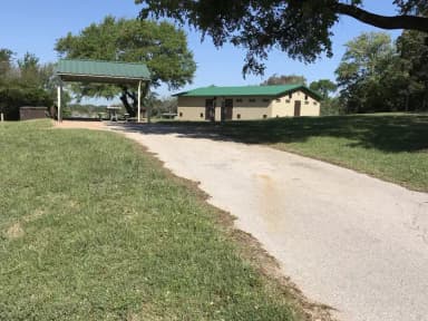 RV site with covered picnic table, grill, fire ring, and restroom/shower facilites nearby