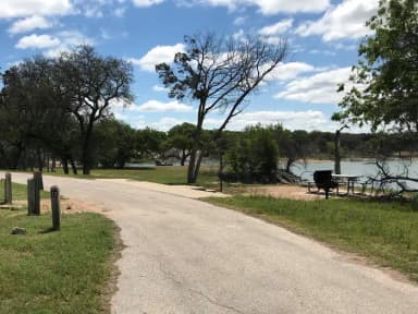 Pull through RV site with picnic table, grill, fire ring, and great view of Waco Lake