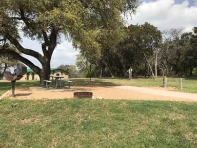 RV site with picnic table, grill, fire ring, and restroom/shower facilities nearby