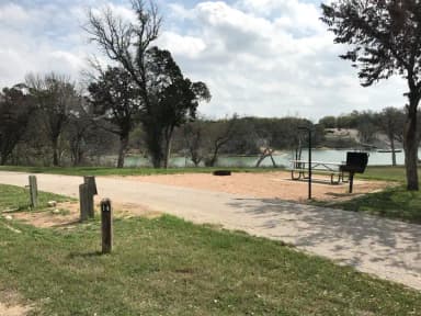 Pull through RV site with picnic table, grill, fire ring, and great view of Waco Lake
