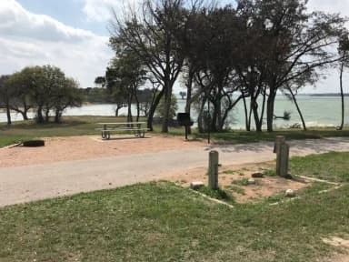 Pull through RV site with picnic table, grill, fire ring, and great view of Waco Lake