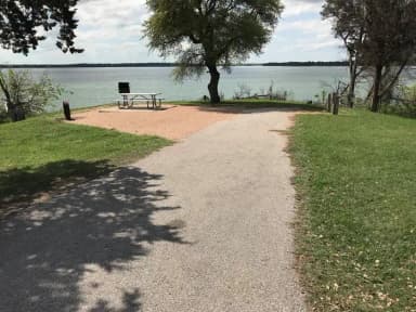 RV site with picnic table, grill, fire ring, and great view of Waco Lake