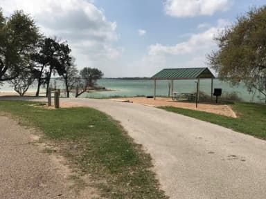 Pull through RV site with grill, fire ring, covered picnic table, and great view of Waco Lake