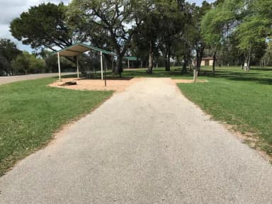 RV site with grill, fire ring, covered picnic table, and restroom/shower facilites nearby