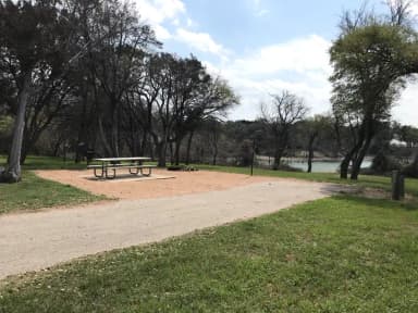 RV site with picnic table, grill, and fire ring
