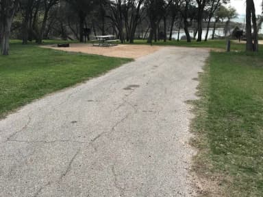 RV site with picnic table, grill, and fire ring