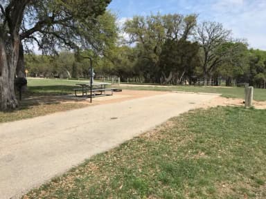 RV site with picnic table, grill, and fire ring
