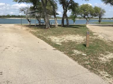 Pull through RV site with grill, fire ring, covered picnic table, and great view of Waco Lake