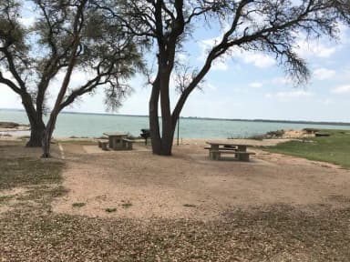 Tent site with picnic table, grill, and fire ring.  Site is located very close to shoreline of Waco Lake
