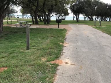 RV site with picnic table, grill, and fire ring