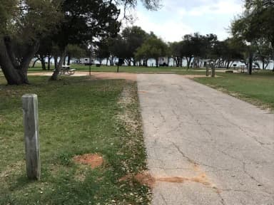 RV site with picnic table, grill, and fire ring