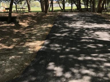 RV site with picnic table, grill, and fire ring