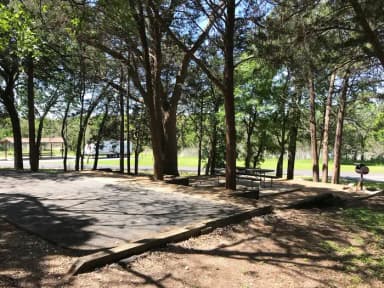 RV site with picnic table, grill, and fire ring