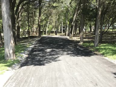 RV site with picnic table, grill, and fire ring