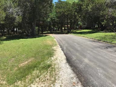 RV site with covered picnic table, grill, and fire ring