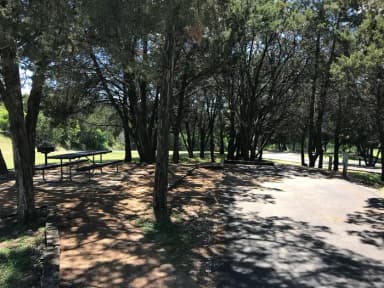 RV site with picnic table, grill, and fire ring